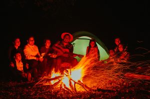 family camping around a campfire